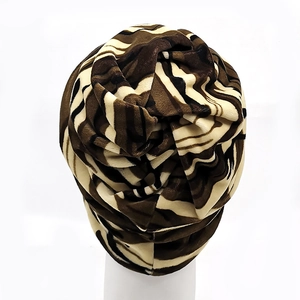 Detailed view of the brown zebra print pattern and pleated texture on the turban hat