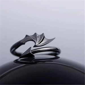 Macro shot of black gothic devil wing open ring featuring sharp arrow tail detail