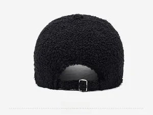 Close-up of the black fuzzy fleece baseball cap showing the adjustable metal buckle back