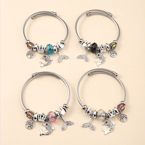Detailed set of 4 cable bracelets featuring dolphin, tree of life, and crown charms