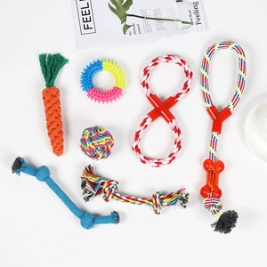 Detail of 7-piece cotton rope dog toy set with woven carrot and rubber rings on white