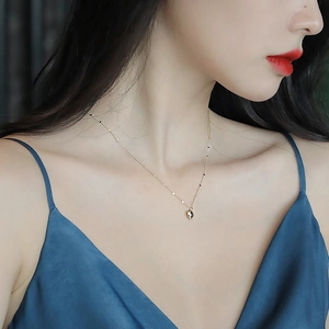 Elegant gold heart pendant necklace for women worn on blue silk with polished finish
