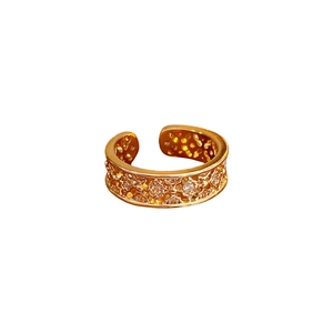 Gold plated lace flower open ring with sparkling cubic zirconia on white background