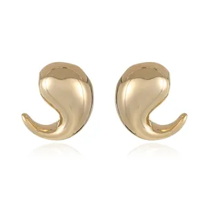 Detailed close-up of polished gold-plated geometric teardrop earrings on white background