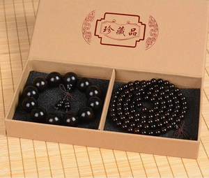 Macro shot of dark ebony wood bead bracelet set inside a premium brown gift box