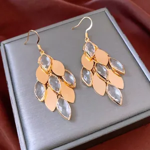 Vintage gold-plated drop earrings with marquise glass crystals and leaf tassels on grey silk