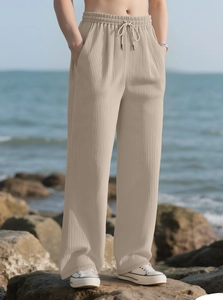 Detail of men's beige ribbed casual trousers featuring elastic drawstring waist and side pockets