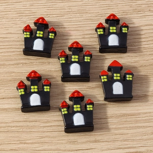 Flat lay of small black Halloween castle charms for DIY phone case accessories