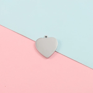 Polished stainless steel heart-shaped pendant DIY accessory on pink and blue background