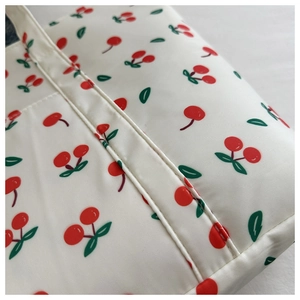 Close-up of durable white nylon tote bag with cute cherry print and reinforced stitching