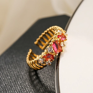 Macro shot of 18K gold plated ring featuring red ruby-colored stones and white zircons