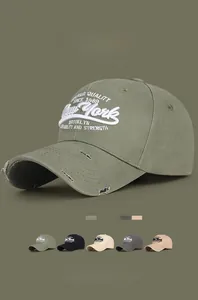 Detailed close-up of 3D New York embroidery and distressed ripped brim on a cotton cap