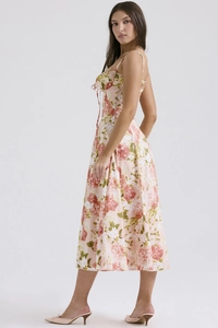 Detail of floral spaghetti strap dress showing drawstring pleated bust and slit hemline