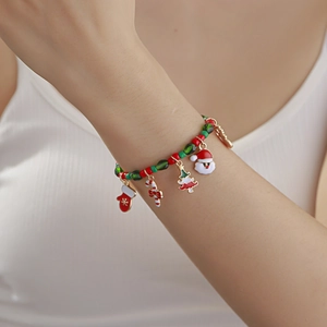 Christmas beaded bracelet with Santa, reindeer and tree pendants worn by a female model