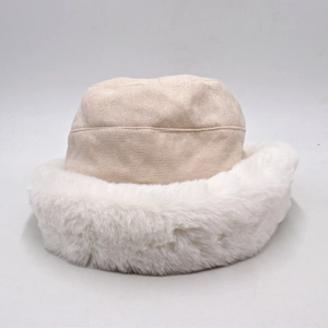 Detail view of winter faux fur bucket hat with beige suede top and thick white plush trim