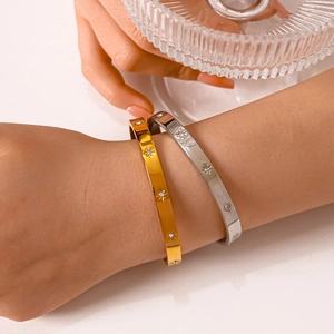 Gold and silver eight-point star bangles with crystals for couples in polished steel