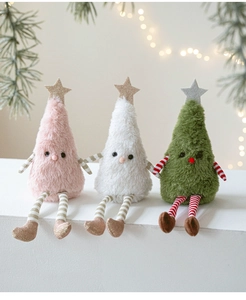 Close-up of three plush Christmas tree dolls with sequined stars on a cozy festive table