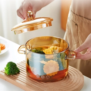 Amber borosilicate glass pot with lid and handles for cooking corn and broccoli
