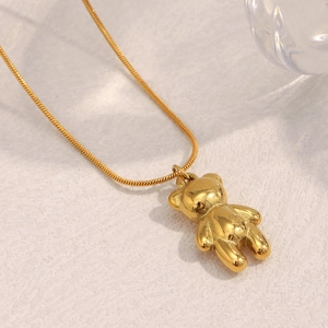 Detail of 18K gold-plated teddy bear pendant on a thin snake chain necklace