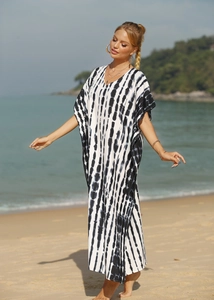 Close-up of lightweight V-neck kaftan featuring black and white tie-dye vertical stripes