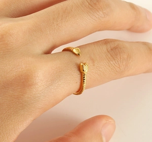 Detailed close-up of golden stainless steel snake ring with realistic scale texture