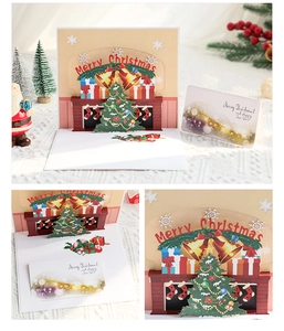 Detail of 3D pop-up Christmas card with Merry Christmas greeting and mini gift tag