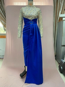 Detail of evening gown featuring sequined mesh bodice and royal blue satin split skirt