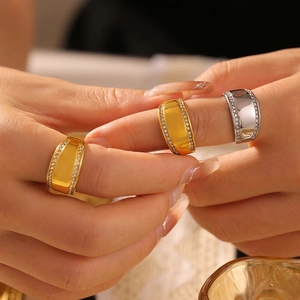 Set of three wide 18k gold and silver plated titanium rings with side diamond accents