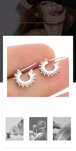 Detailed macro view showing the polished silver geometric sunburst earring design