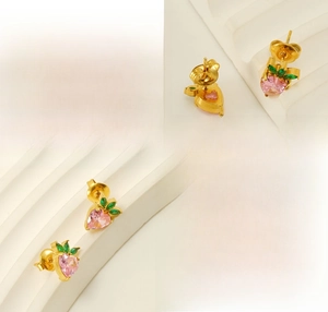 Detail of peach ear studs showing polished gold plating and pink heart zircon stones
