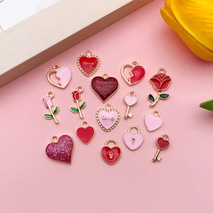 Flat lay of 16 gold-plated heart and rose enamel charms for DIY jewelry making