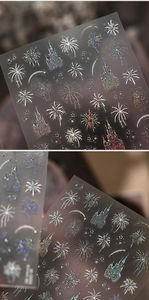 Detail of laser iridescent nail stickers with fireworks and castle silhouettes on dark background