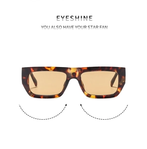 Close-up of tortoise shell rectangular frame with amber lenses on a white background