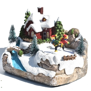 Détail d'un village de Noël miniature avec patineurs rotatifs et décorations lumineuses