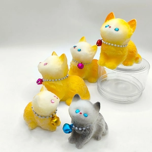 Close-up of soft flocked cat stress toys with colorful bells and pearl necklaces