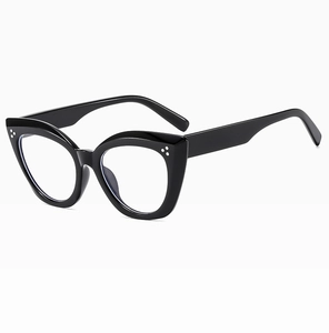 Close-up of glossy black cat-eye frames with stylish rivet details and clear lenses