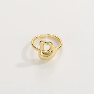 Close-up of a polished 18K gold D-shaped adjustable ring with smooth open band design