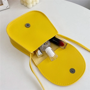 Yellow PU leather mini cat crossbody bag for kids showing inner storage capacity