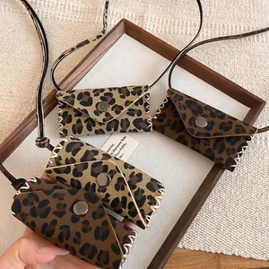 Mini leopard print leather bag necklace with envelope flap and woven trim detail