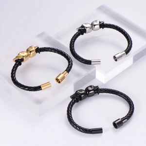 Detailed macro view of woven leather bracelets with skull charms and steel magnetic clasps
