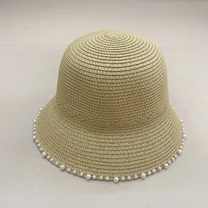 Detailed top view of khaki straw hat with elegant white pearl trim around the brim