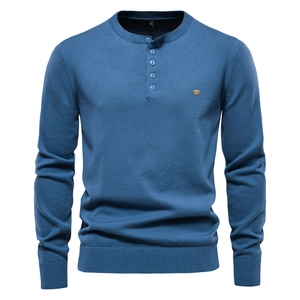 Detailed close-up of blue knit sweater featuring Henley collar buttons and M size label