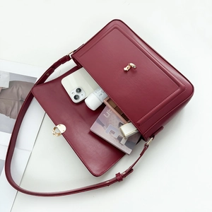 Detail view of the deep red leather bag interior showing high storage capacity and turn lock