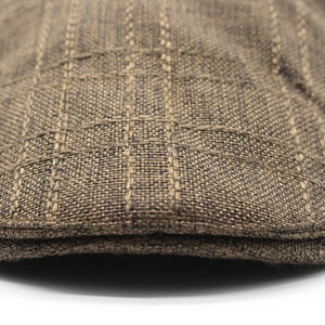 Detailed macro view of the brown plaid cotton linen flat cap with thick woven edges
