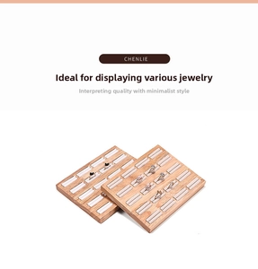 Macro view of solid wood jewelry ring display tray with white padded multi-slot inserts