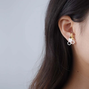 Handmade S925 sterling silver honeycomb bee stud earrings worn on a woman's ear