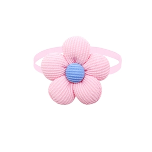 Detail of pink knitted flower pet bowtie with light blue center and elastic band