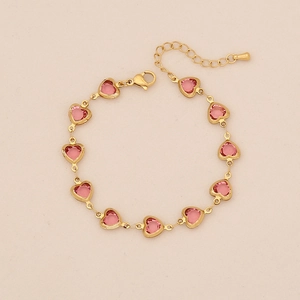Detail of pink heart gemstones on a gold stainless steel chain with lobster clasp