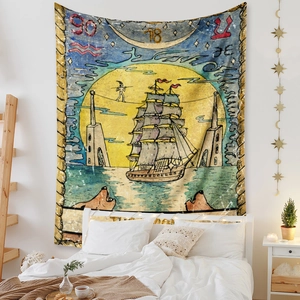 Detail of vintage tarot style tapestry with sailing ship and moon on a bedroom wall