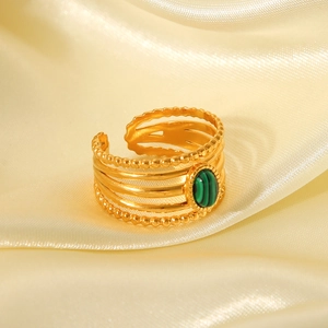 Detail of French vintage ring featuring natural malachite stone and hollow gold-plated band